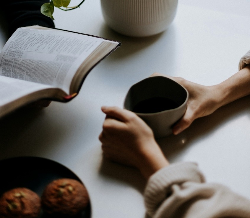 bible, coffee, cake on table